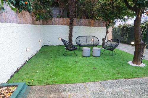 two chairs and a table in a yard with grass at Magical villa western peloponnese by MPS in Pýrgos