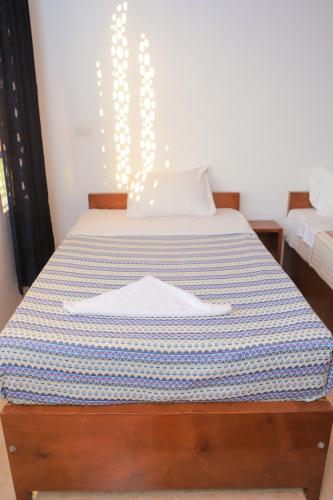a bed with a blue and white striped mattress at El Hanna Valley View in Luxor