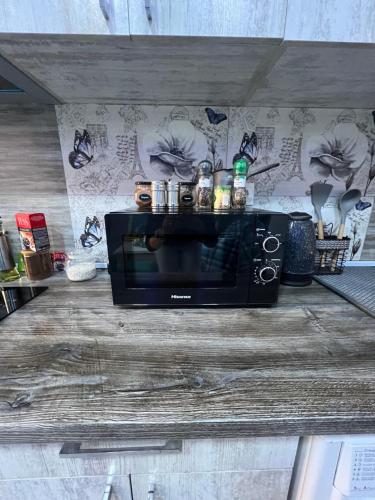 a microwave sitting on top of a wooden table at Cool Blue Interior SELF CHECK IN in Yerevan