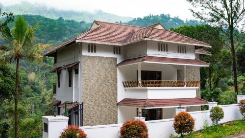 a house with a view of the mountains at The Cascade Munnar in Anachal