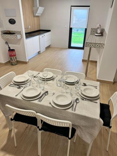 stół z talerzami i okularami w kuchni w obiekcie Alojamientos Robustiana w mieście Santander