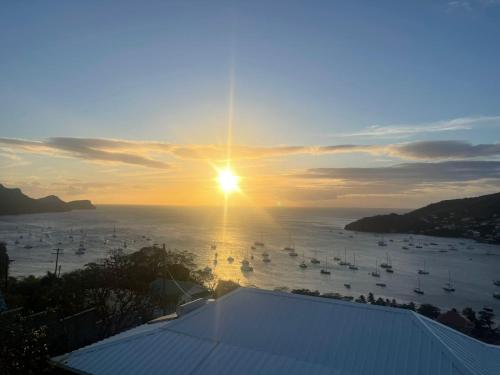 a sunset over a body of water with boats at Immaculate 3 Bed Villa Overlooking Admiralty Bay in Union