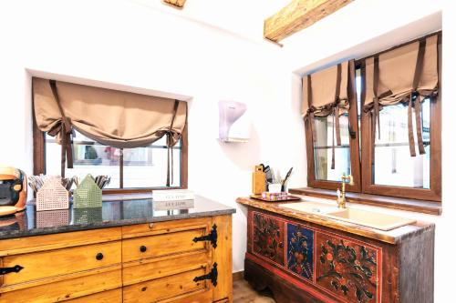 a bathroom with a wooden dresser and a sink at Casuta cu Mar de la Joyard in Porumbacu de Sus