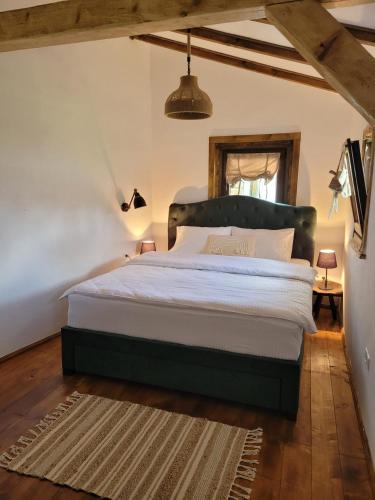 a bedroom with a large bed in a room at Casuta cu Mar de la Joyard in Porumbacu de Sus
