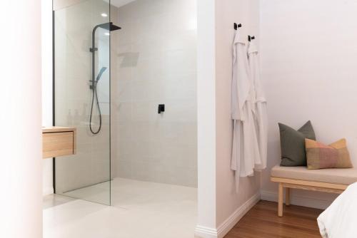 een badkamer met een douche en een glazen deur bij Villa Gwen: Character Home Moments from the City in Invermay