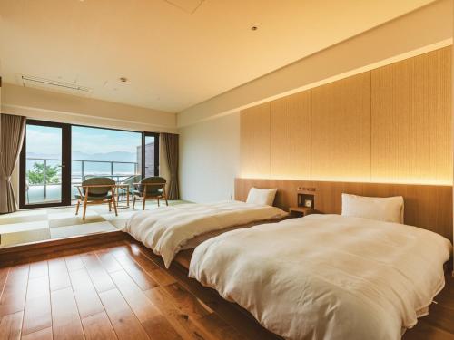 Ein Bett oder Betten in einem Zimmer der Unterkunft Etajimasou Hotel & SPA Hiroshima