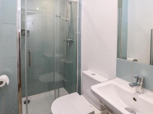 a bathroom with a shower and a toilet and a sink at Fleming House in Cowes