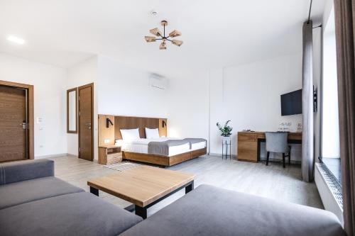 a living room with a couch and a bed at Otto Hotel-Restaurant in Rivne
