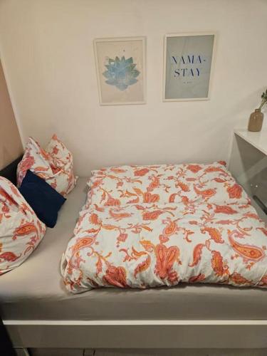 a bed with a comforter and pillows on it at Schönes Apartment in München in Munich
