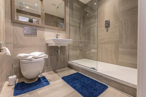 a bathroom with a toilet and a sink and a shower at The Lexington - Luxury Serviced Apartments City Centre - City and Waterfront views in Liverpool