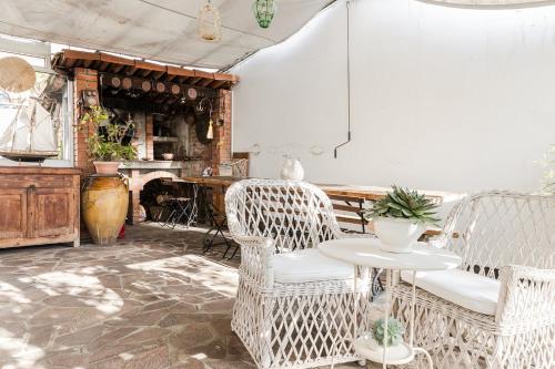 サン・バルトロメーオ・アル・マーレにあるCasa delle Zagareの籐の椅子2脚とテーブルが備わるお部屋
