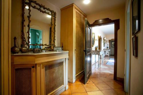 a bathroom with a sink and a mirror and a hallway at Villa Antico Toscano in Polistena
