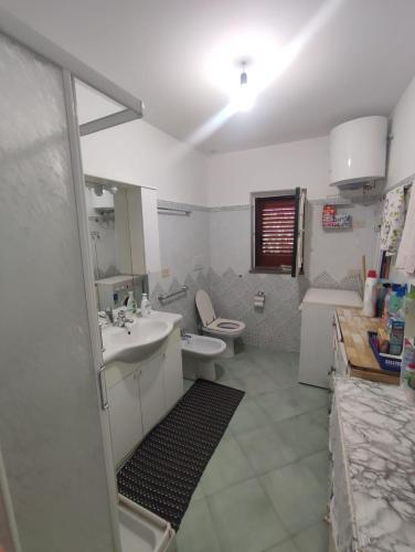 a bathroom with a sink and a toilet at Casa Amena con ampio terrazzo e giardino in Lipari