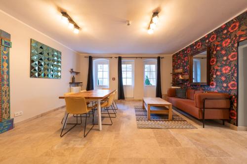 a living room with a table and a couch at Design Apartments - "Villa Arnim" in Potsdam
