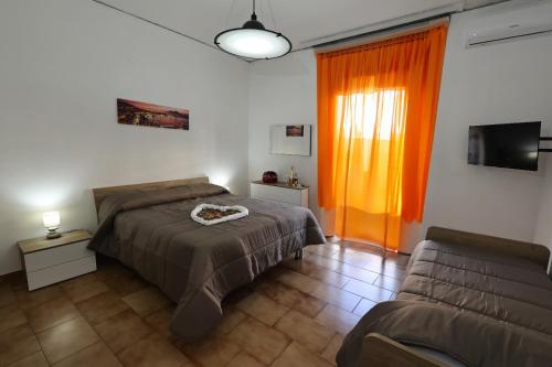 a bedroom with a bed and a couch at Vesuvio Guest House in Ercolano
