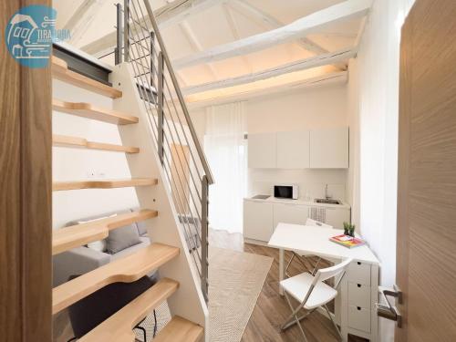 a staircase in a small apartment with a desk at Basovizza 3 Nicole Tirabora Short Rent in Villa Opicina