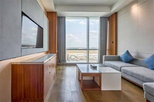 a living room with a couch and a tv at VM Hotel in Phnom Penh