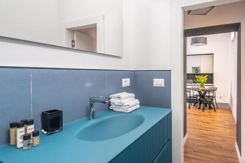 a bathroom with a blue counter with a sink at Tavernola35 - Luxury apartment in Castellammare di Stabia
