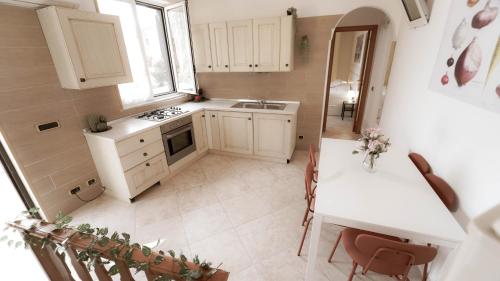 a small kitchen with a sink and a table at Casa nel borgo dei gatti in Cetara