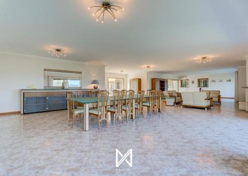 a dining room and living room with a table and chairs at MyStay - Lagos House in Braga