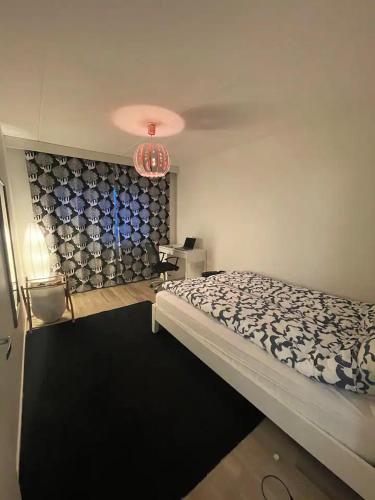 a bedroom with a bed and a chandelier at comfort room in Helsinki