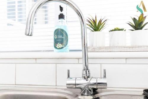 a kitchen sink with a bottle of dish soap at 5 Double Bedrooms with Ensuites - Teesside House TSAC in Redcar