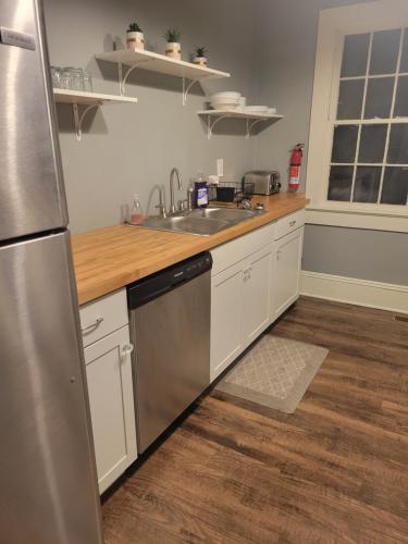 a kitchen with a stainless steel refrigerator and a sink at Natural Bridge Hotel, Trademark Collection by Wyndham in Natural Bridge