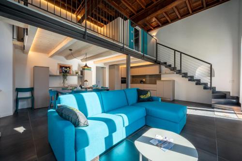 a living room with a blue couch and a table at NEW 2024 - ANCIENT GRAVEDONA - where Lake Como classic style meets modern design and comforts - Larihome A41 in Gravedona