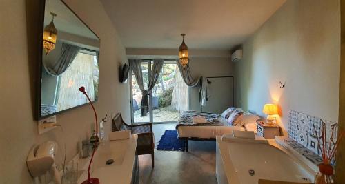 a living room with a couch and a bed and a mirror at Les Suites in Santa María de Palautordera