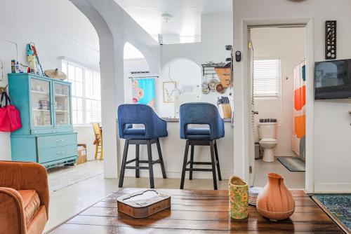 a living room with two blue chairs and a table at Annes Revenge The Bonney Overlook in Christiansted