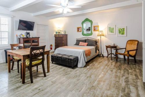a bedroom with a bed and a desk and a table at Zen Treasure - A Mateys Retreat in Christiansted