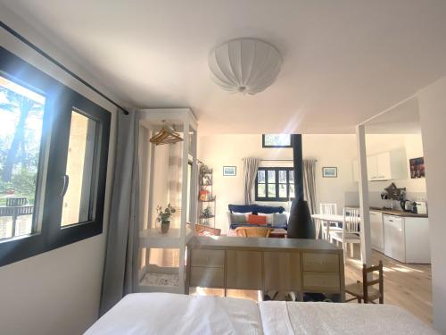 a bedroom with a bed and a desk and a kitchen at Studio de l'oliveraie in Aix-en-Provence