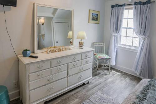 a bedroom with a dresser with a large mirror at The Mary Read - A Pirates Serenity in Christiansted