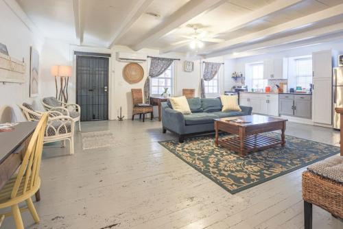 a living room with a couch and a table at The Captains Quarters - A Relaxing Nautical Abode in Christiansted