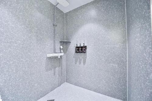 a bathroom with a shower stall with a shower at Daegu February Hotel Lions Park in Daegu