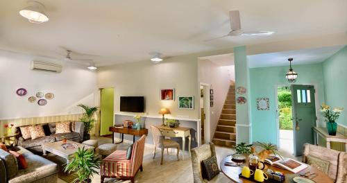 a living room with a couch and a table at Karma Chalets in Gurgaon