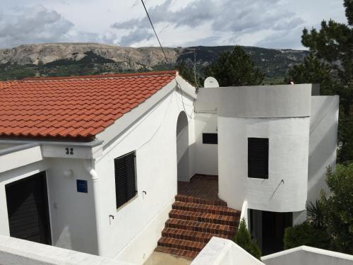 a white house with a red roof at Apartments Peace&Love in Baška