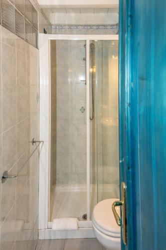 a bathroom with a glass shower with a toilet at Luxury Seaview Apartments Manarola by Arbaspàa in Manarola