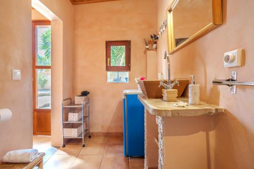 a bathroom with a sink and a blue refrigerator at Villa KASHMIR in Artá