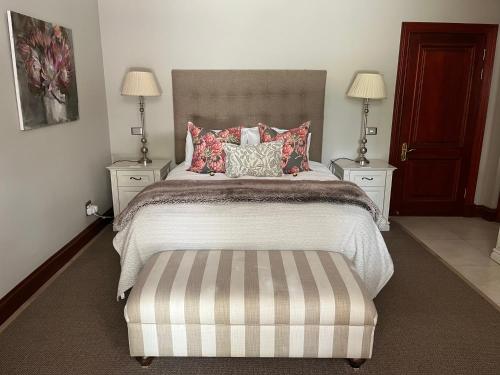 a bedroom with a bed with two night stands and two lamps at The Courtyard at La Loggia in Nottingham Road