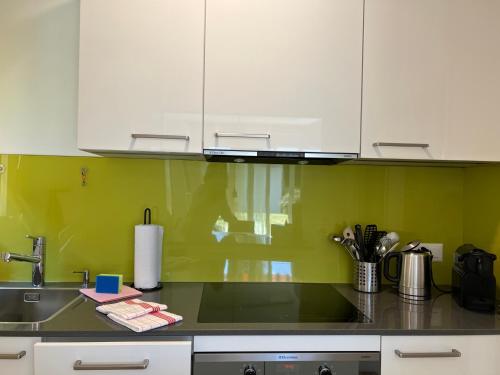a kitchen with white cabinets and a sink at Muralto - Locarno: Miramonti Apt.5 in Muralto