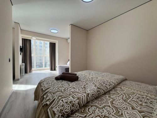 a bedroom with a bed with a pillow on it at Apartments near Pechersk metro station in Kyiv