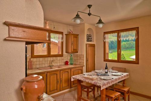 a kitchen with a table with chairs and a sink at Chalet de 5 chambres avec wifi a Aime a 1 km des pistes in Aime-La Plagne