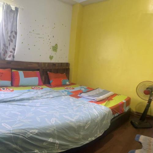 a bedroom with a large bed with colorful pillows at Haven Seaview Homestay in Lanyu