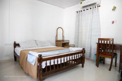 ein Schlafzimmer mit einem Bett, einem Tisch und einem Stuhl in der Unterkunft Coral Paradise Beach Resort, Lakshadweep in Agatti