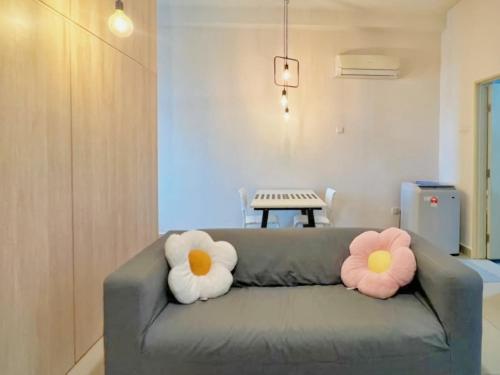 two pillows on a couch in a living room at Mount Austin Palazio Homestay johor bahru in Johor Bahru
