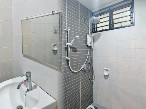 La salle de bains est pourvue d'une douche, d'un lavabo et d'un miroir. dans l'établissement Mount Austin Palazio Homestay johor bahru, à Johor Bahru