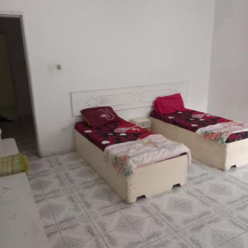 two beds sitting in a room with at Lakhdar saaoudi in Nouakchott