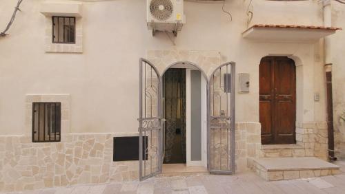 an entrance to a building with two wooden doors at Casa Laura in Vieste
