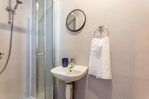 a bathroom with a sink and a shower and a mirror at Room 03 - Sandhaven Rooms Double in South Shields